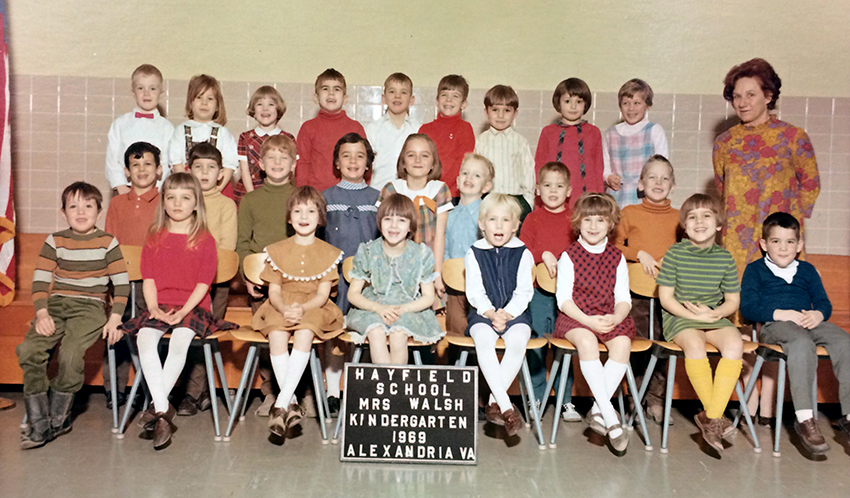 Color class photograph from the 1968 to 1969 school year showing some of the first kindergarteners enrolled in our school and in FCPS. 25 children are pictured, an even mix of boys and girls, and their teacher, Mrs. Walsh is standing behind them on the right. 